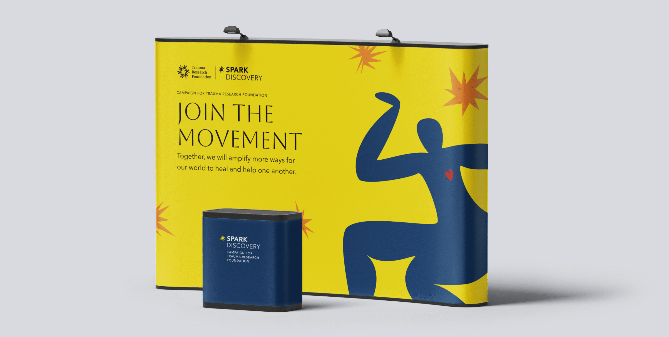 Yellow and blue trade show booth with abstract figure and text “Join the Movement.”